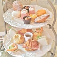 Small afternoon tea treats served on an ornate 2 tier tray.