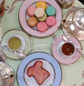 Afternoon tea treats laid out on cute pastel colored tea ware.
