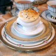 A small souffle soup on stacks of vintage tea saucers.