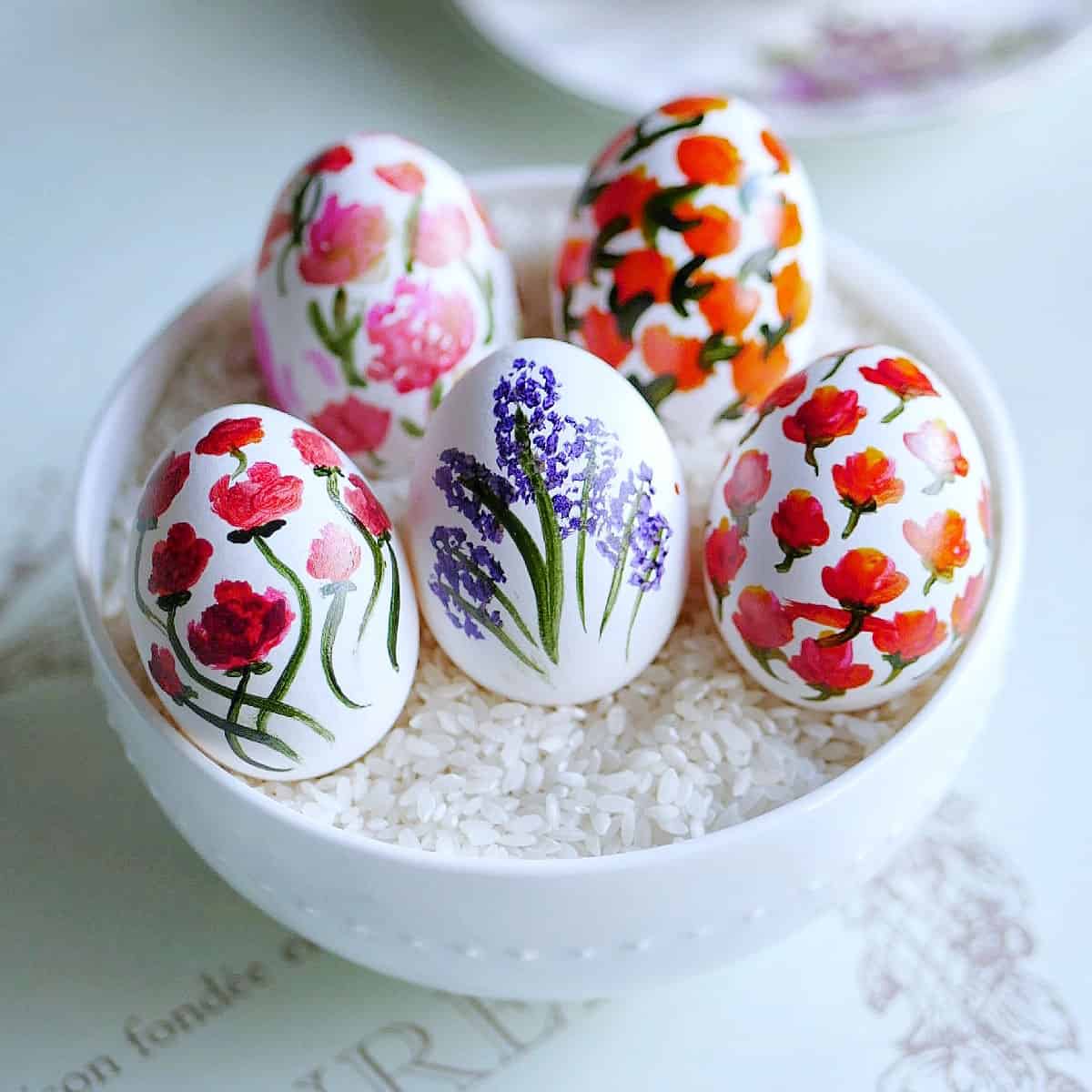 Colorful Easter eggs in a small white bowl.