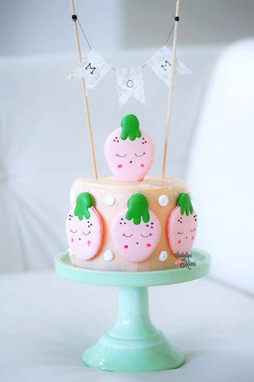 Strawberry macarons on a mini cake. 