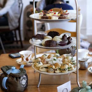 Afternoon tea display featuring assorted pastries, scones, and desserts at The Secret Garden.