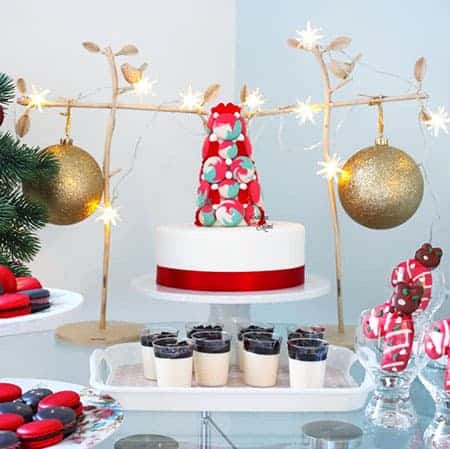 A Christmas sweets table with a macaron tower and cake. 