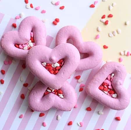 Large heart macarons with sprinkles poured inside. 