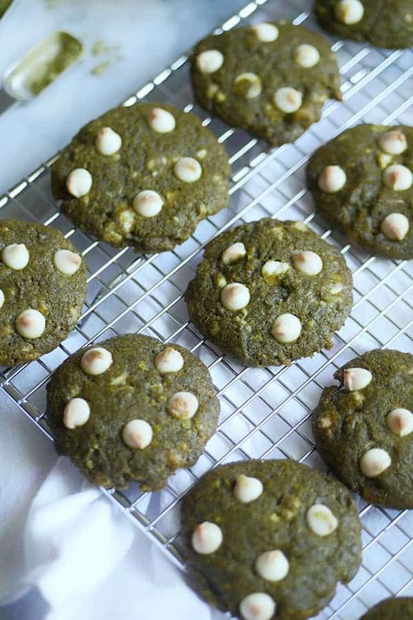 Close up of slightly browned white chocolate on top of matcha cookies.