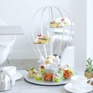 Afternoon tea served on a tea display resembling a parachute.