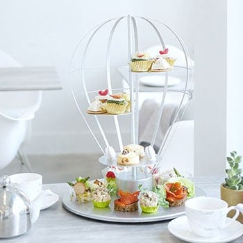 Afternoon tea served on a tea display resembling a parachute. 