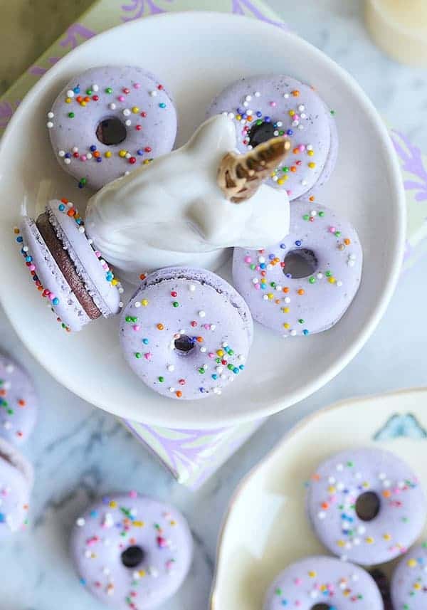 lavender donut macarons on a unicorn plate shot from above. 