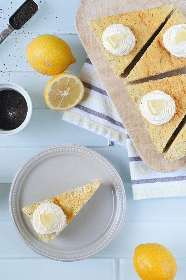 Lemon cheesecake shown with lemons and earl grey tea leaves. 