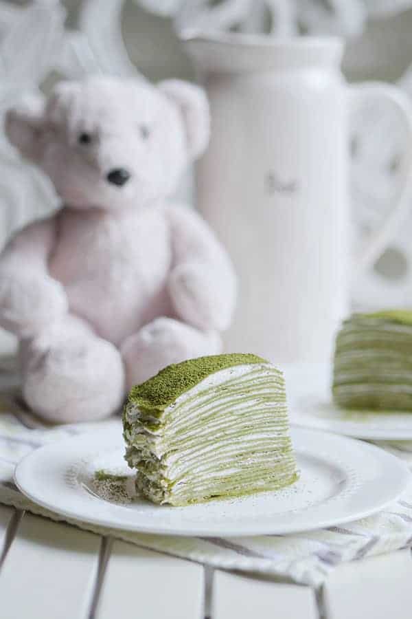 A cross section slice of matcha mille crepe that shows all 28 layers of crepes in the cake. 