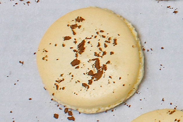 Macaron that is overbaked, browned, hard and dry. 