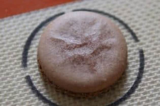 Macaron shell that is wrinkled and blotchy. 