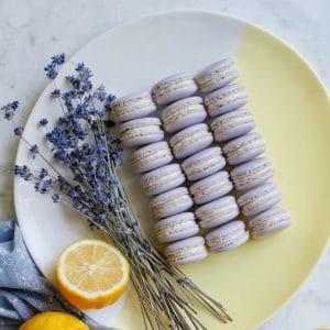 purple macarons on a dish with lavender and lemons
