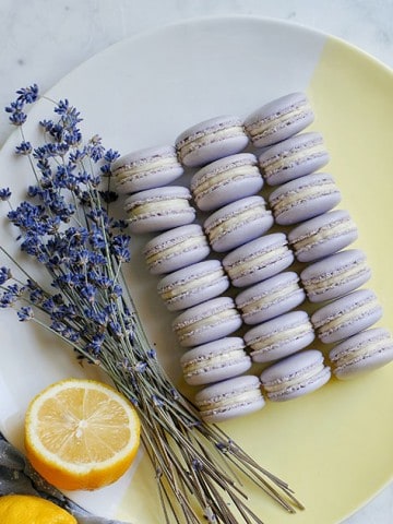 purple macarons on a dish with lavender and lemons