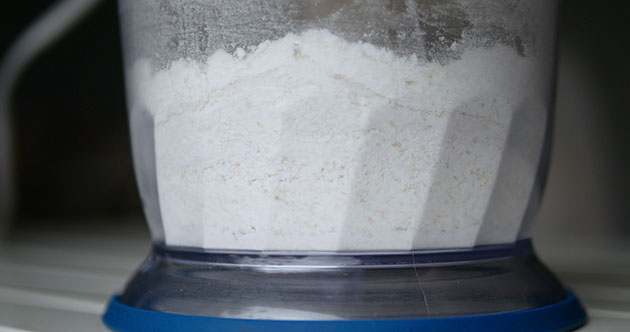 Close up of food processor grinding almond flour. 