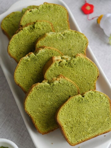 8 slices of matcha pound cake on a long serving dish.