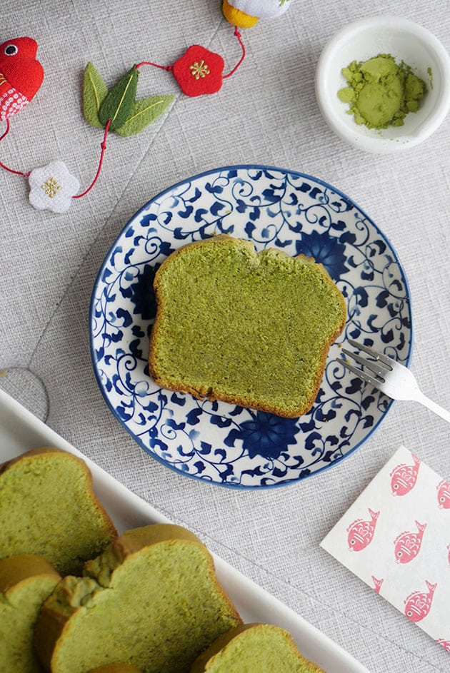 A piece of matcha pound cake on a small dessert plate with japanese motif. 