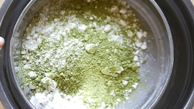 Matcha and icing sugar and flour being sifted. 