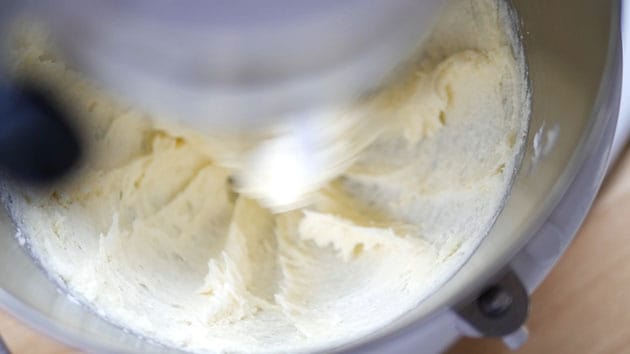 Cream cheese being whipped in pound cake batter. 