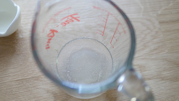 Close up of measuring cup with bloomed gelatin in a solid form. 