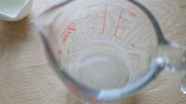 Gelatin has become liquid inside a measuring cup. 