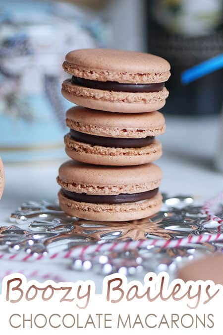 A stack of Irish Cream Chocolate macarons set against Christmas ornaments. 