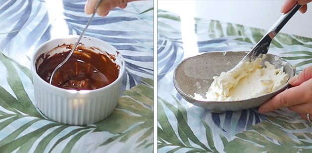 Hand stirring melted chocolate in a ramekin. Cream cheese in a bowl at a spreadable consistency. 