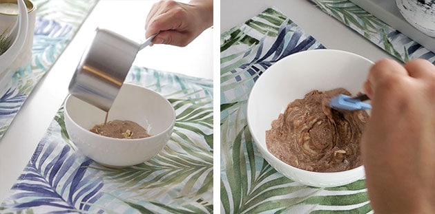 Hot gingerbread cream being poured onto chopped whtie chocolate and then blended with spatula.