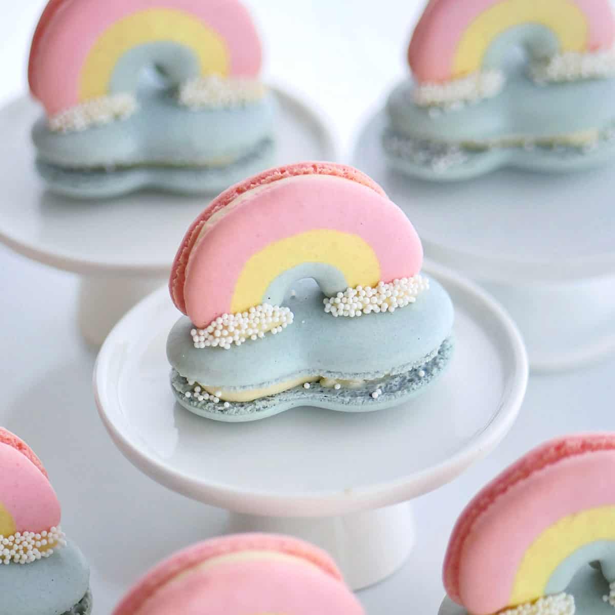 3D rainbow macarons perched on top of a cloud macaron.