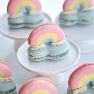 3D rainbow macarons perched on top of a cloud macaron.