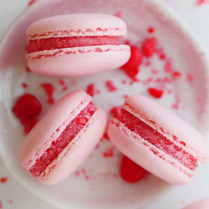 Close up of cinnamon heart candy macarons on a dish.