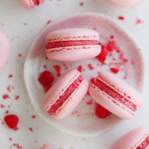 Cinnamon heart candy macarons on a small plate.