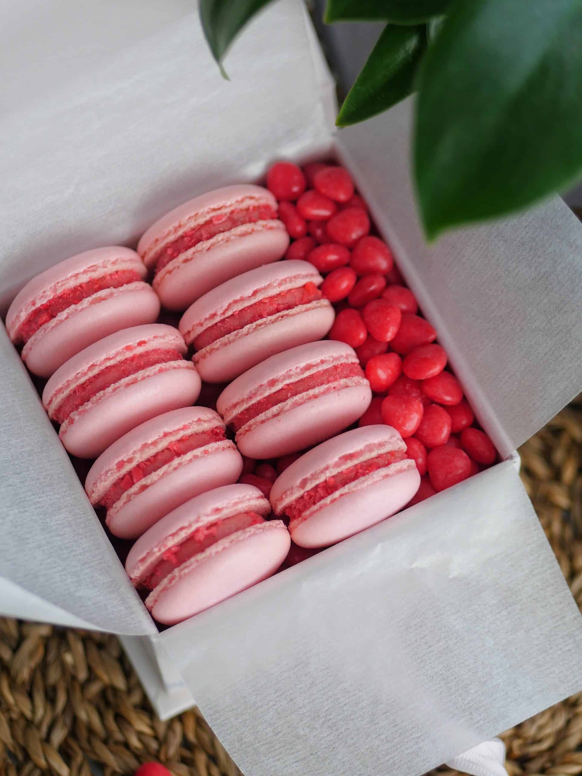 Macarons made without mixer displayed inside a gift box. 