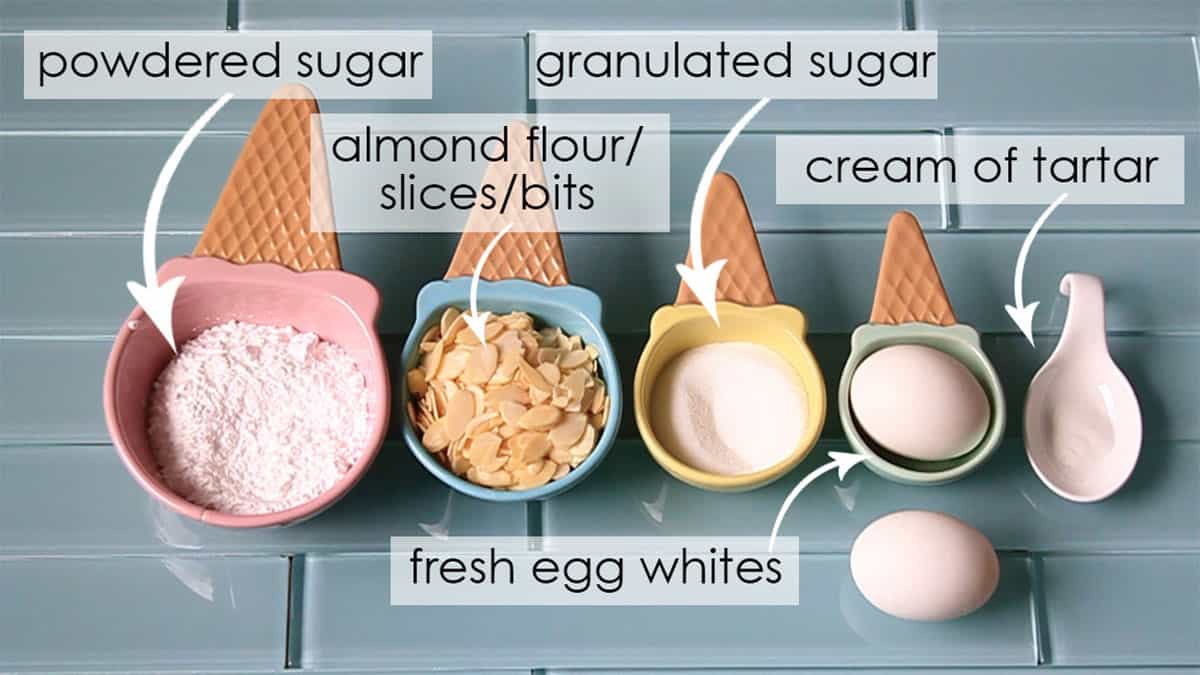 Basic macaron ingredients in measuring cups on counter. 