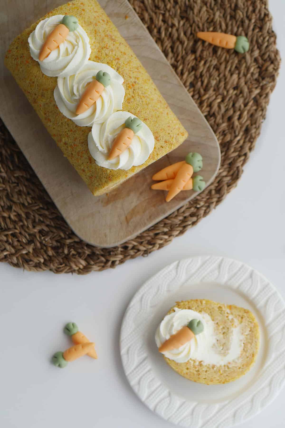 Top view of fully assembled carrot cake with a slice cut out and placed on a small plate. 