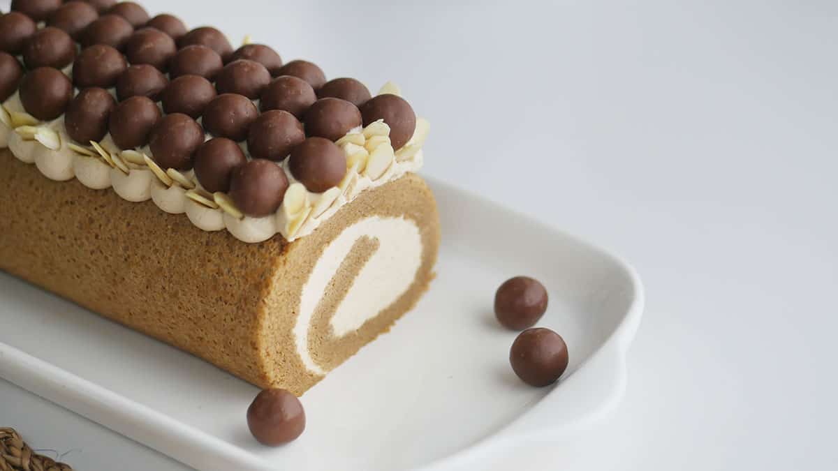 Coffee cake with Kaluha cream on a long white plate.