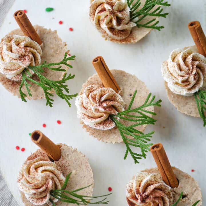 Top down view of gingerbread cheesecake cups on a white serving platter.
