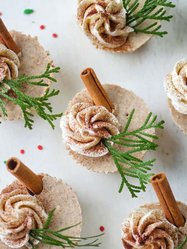 Top down view of gingerbread cheesecake cups on a white serving platter.