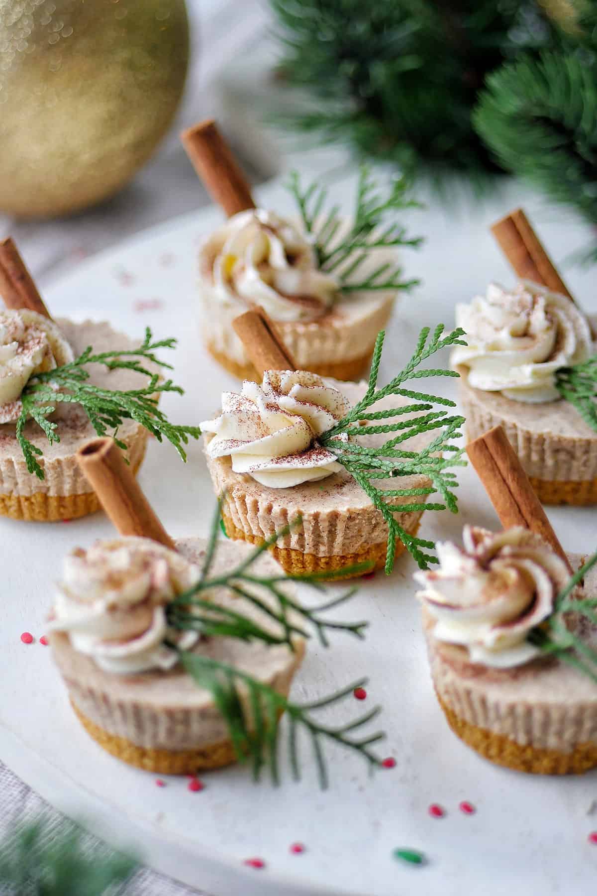 A set of gingerbread cheesecake cups on a white serving platter. 