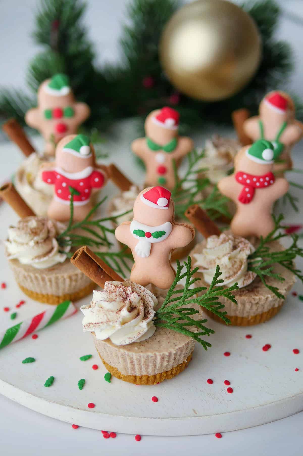 Gingerbread cheesecake cups topped with cute gingerbread man macarons. 