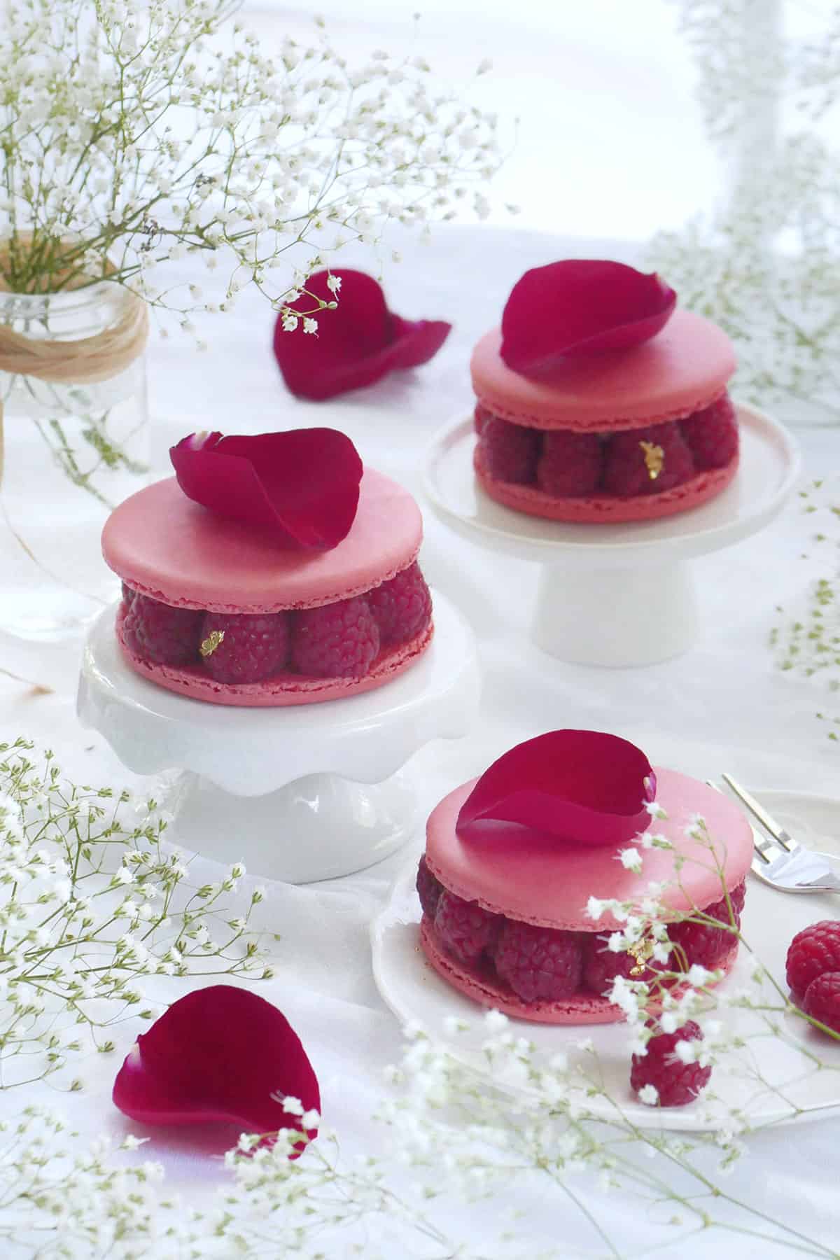 A trio of macaron cakes made with raspberries, lychee and rose. 