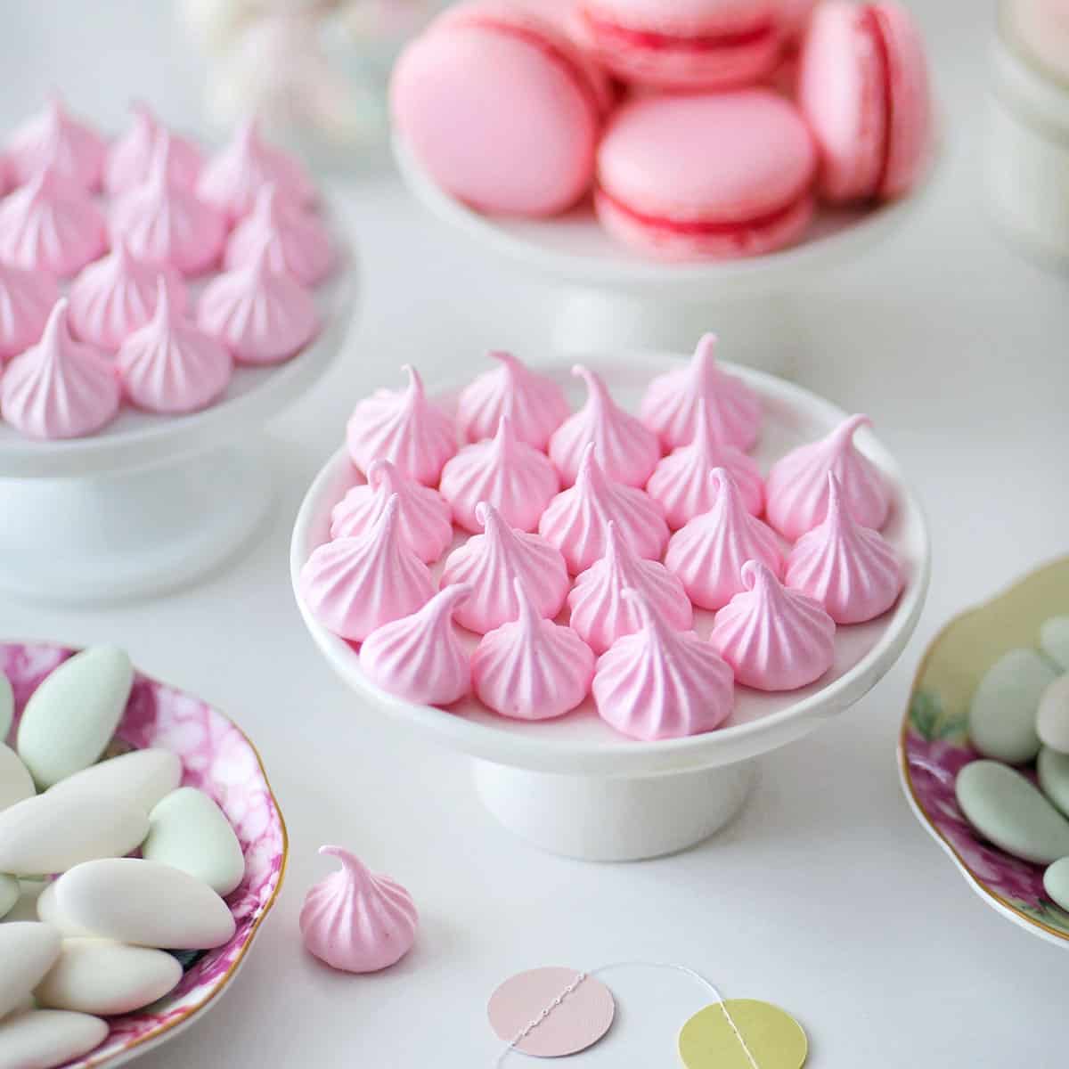Close up of pink cotton candy flavored meringue kisses.