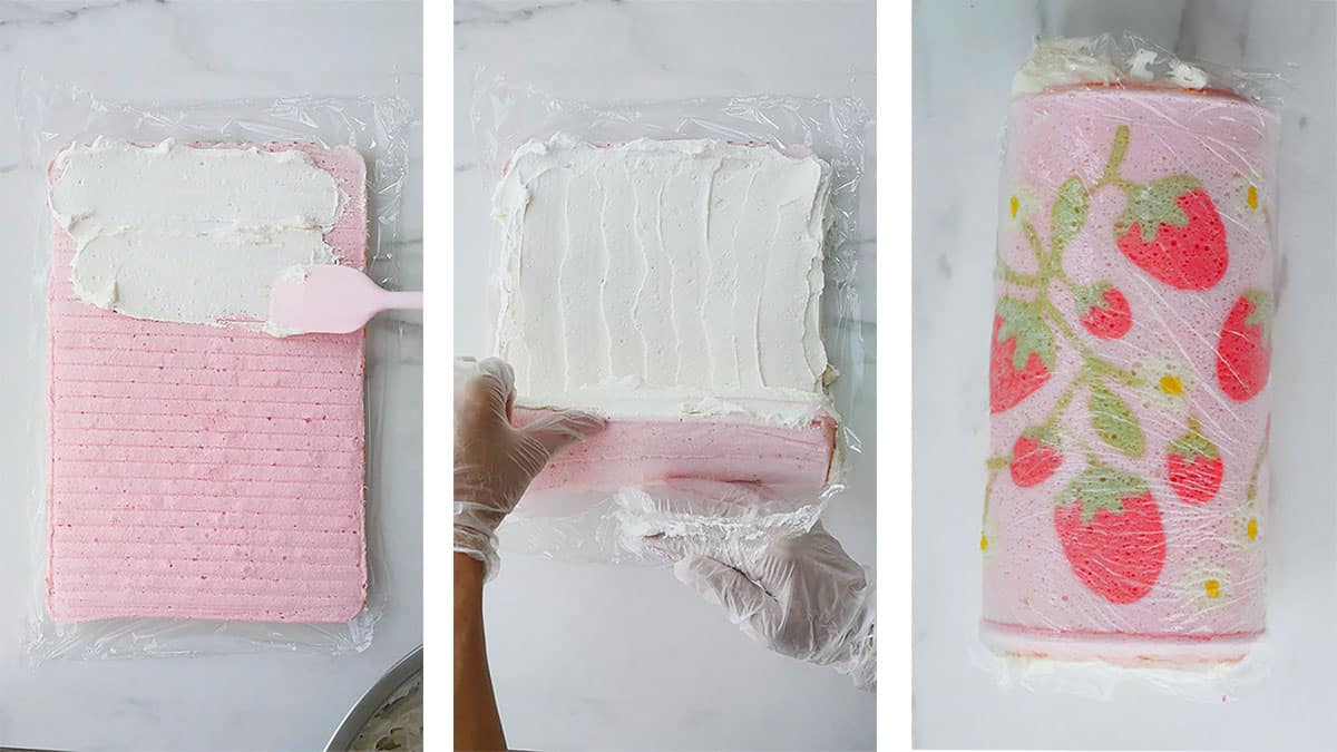 Pink cake roll being rolled and then wrapped with plastic wrap. 