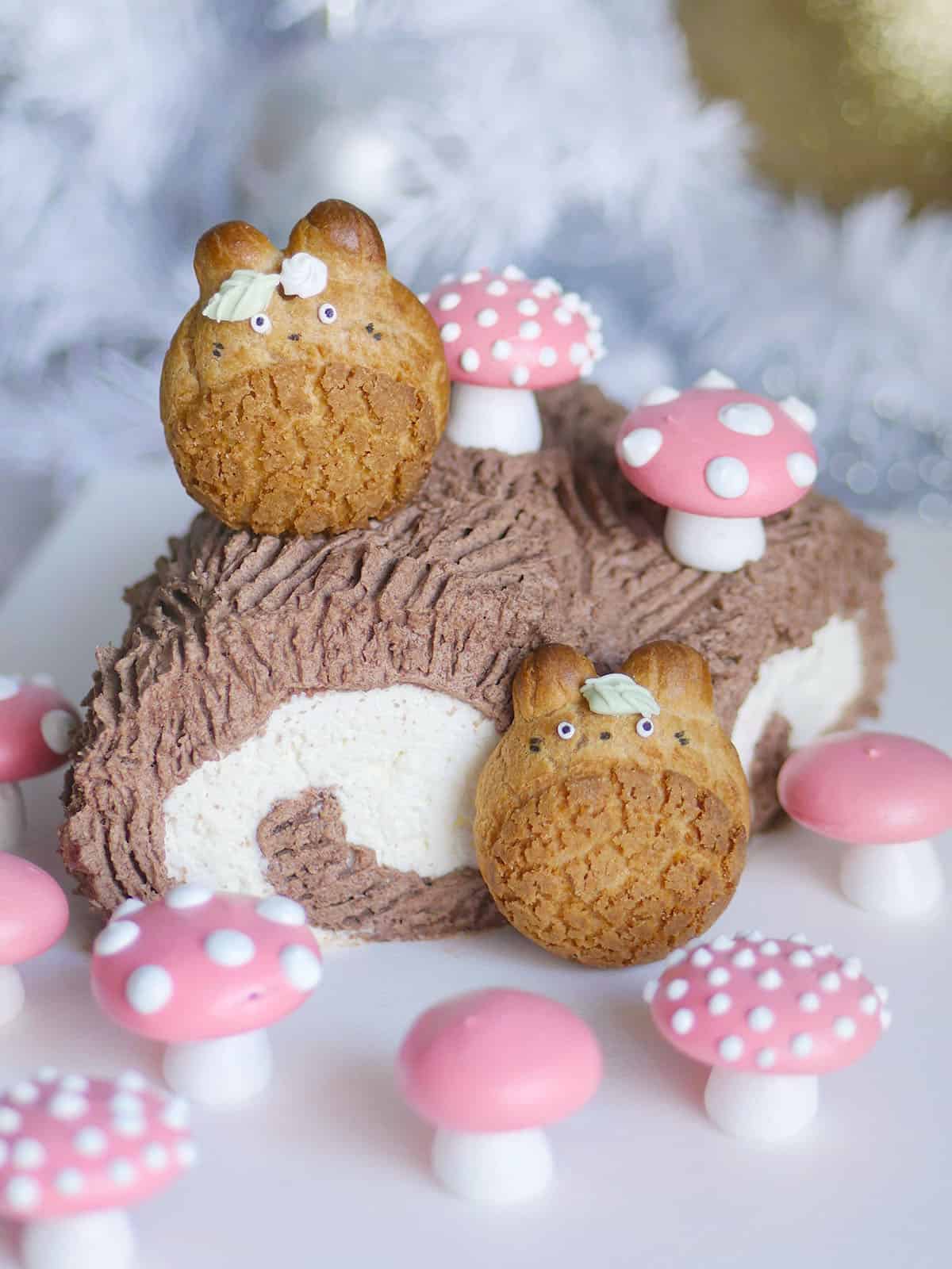 Close up of 2 Totoro cream puffs on the Japanese yule log. 