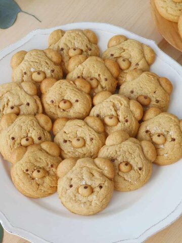 A plate filled with bear shaped cookies.