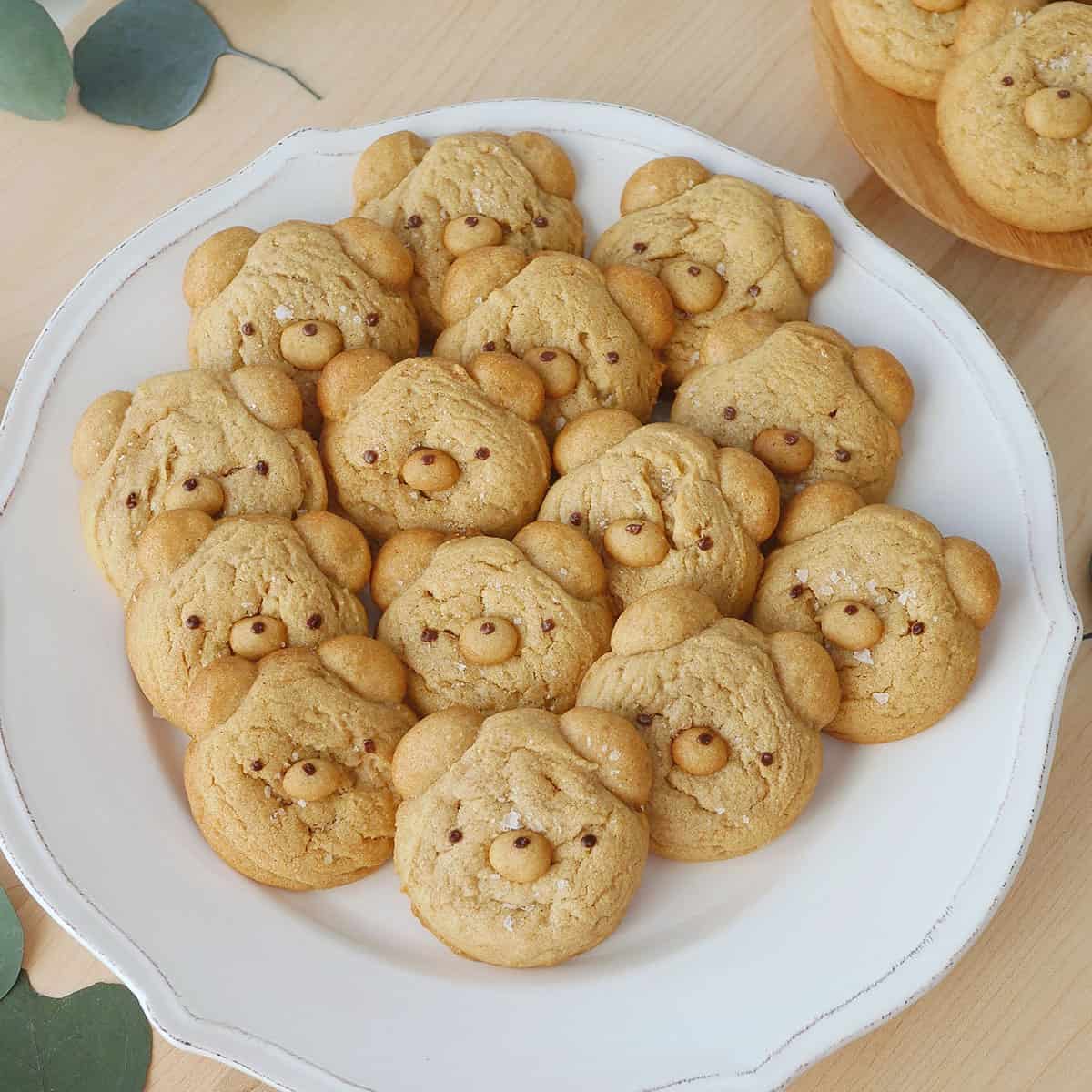 A plate filled with bear shaped cookies.