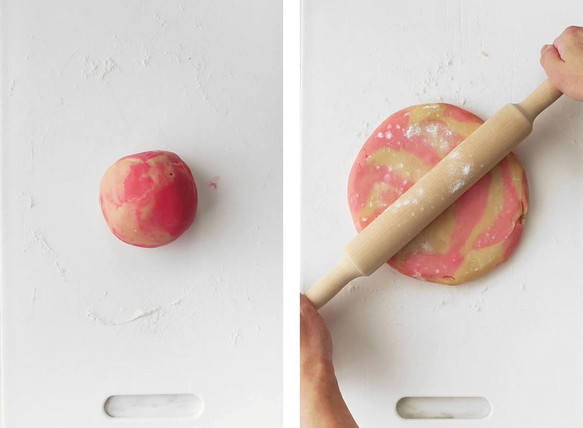 The marbled looking cookie dough is rolled into a ball and rolled out flat with a rolling pin.