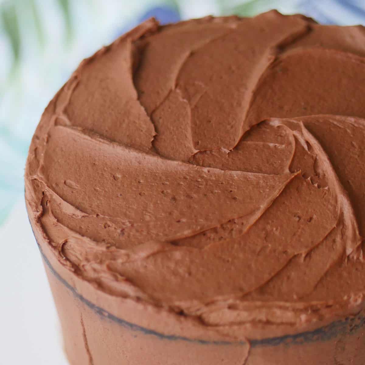 Close up of chocolate frosting on cake as viewed from the top.