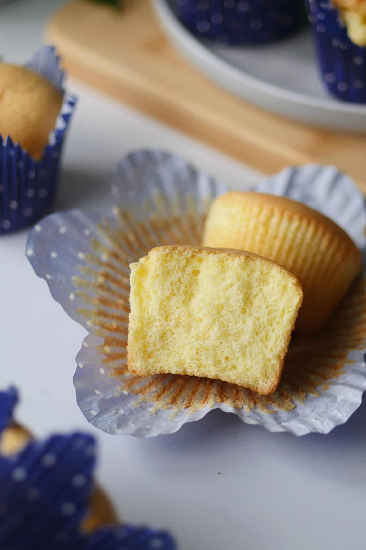 Close up of inside of the cupcake showing the small fine open crumbs. 