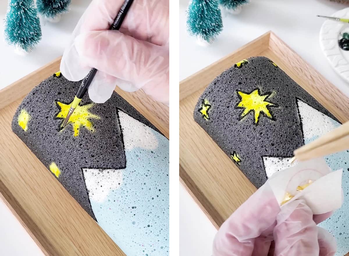 A hand is painting the outlines of the Bethlehem star on the cake roll. 